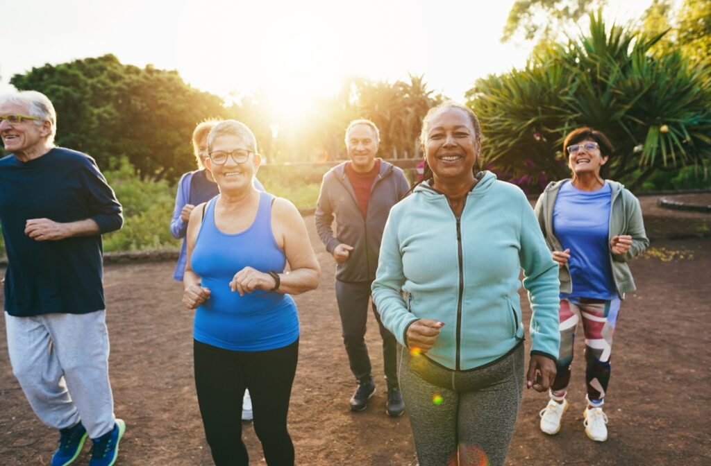 a group of seniors are jogging together as part of their senior exercise program.