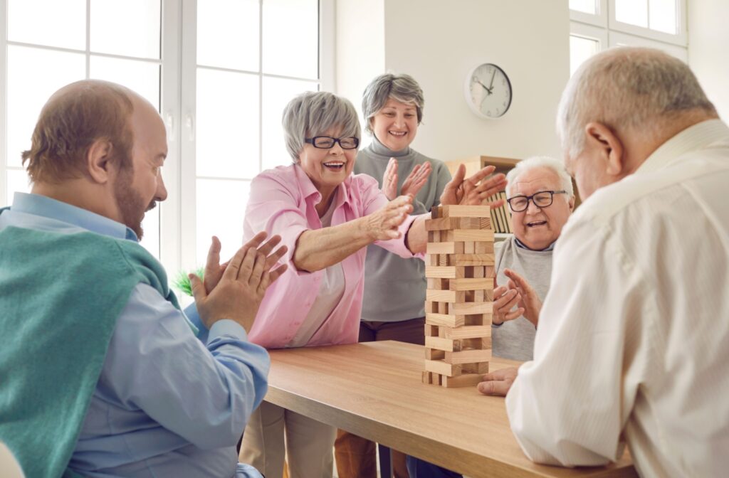 A group of seniors happily playing board games together.