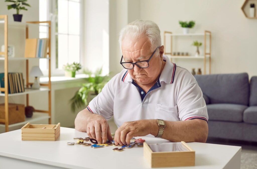 A senior putting together a puzzle with all the pieces